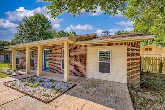 333 Western Pine Rd, Cantonment, FL 32533 - back of property featuring brick siding, a patio, and fence