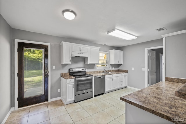 333 Western Pine Rd, Cantonment, FL 32533 - kitchen with under cabinet range hood, white cabinets, a wealth of natural light, and appliances with stainless steel finishes