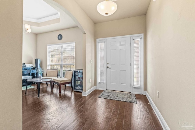 entryway featuring ornamental molding and dark hardwood / wood-style flooring