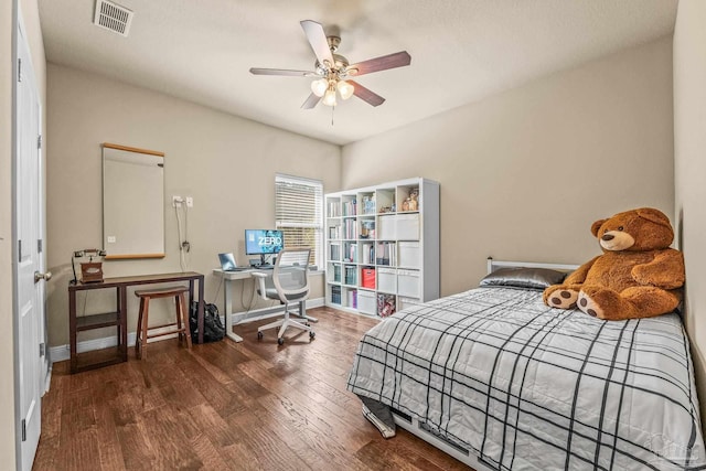 bedroom with dark hardwood / wood-style flooring and ceiling fan