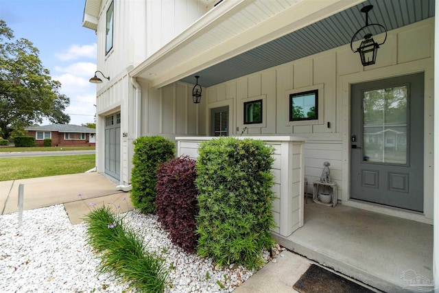 2550 N 11th Ave, Pensacola, FL 32503 - doorway to property featuring board and batten siding and covered porch