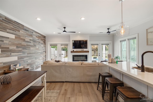 2550 N 11th Ave, Pensacola, FL 32503 - living room with ceiling fan, a fireplace, french doors, recessed lighting, and light wood-style flooring