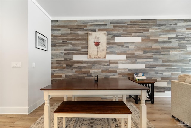 2550 N 11th Ave, Pensacola, FL 32503 - detailed view of an accent wall, baseboards, and wood finished floors