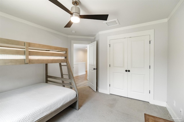 2550 N 11th Ave, Pensacola, FL 32503 - bedroom with light carpet, ornamental molding, a closet, a ceiling fan, and baseboards