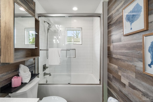 2550 N 11th Ave, Pensacola, FL 32503 - full bathroom featuring toilet, wooden walls, shower / bath combination with glass door, healthy amount of natural light, and recessed lighting