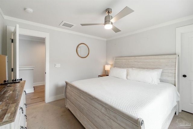2550 N 11th Ave, Pensacola, FL 32503 - bedroom featuring baseboards, ornamental molding, a ceiling fan, and light colored carpet