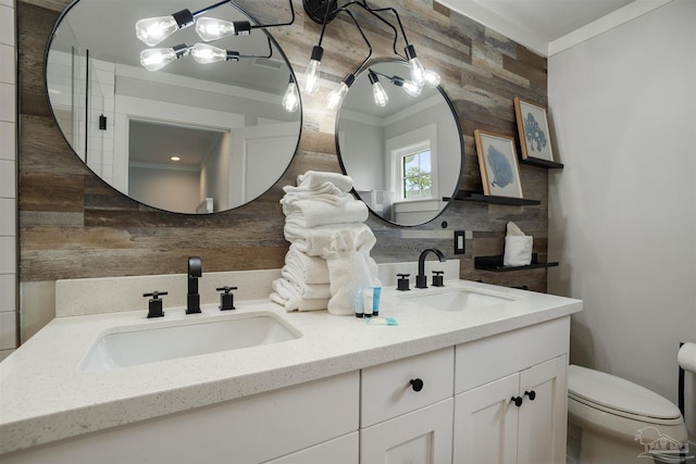 2550 N 11th Ave, Pensacola, FL 32503 - bathroom featuring double vanity, ornamental molding, toilet, and wood walls