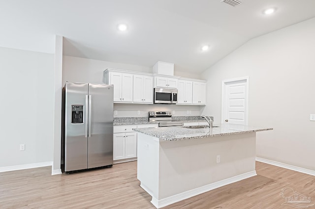 7929 Huntington Creek Ln, Pensacola, FL 32526 - kitchen with stainless steel appliances, a sink, white cabinets, an island with sink, and vaulted ceiling