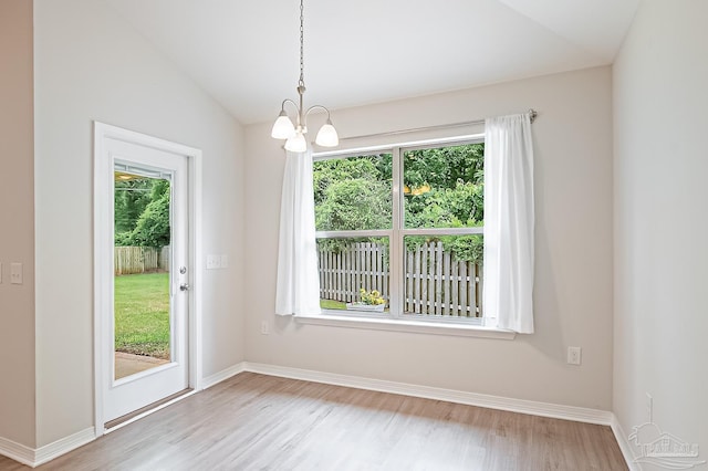 7929 Huntington Creek Ln, Pensacola, FL 32526 - unfurnished dining area with wood finished floors, a chandelier, lofted ceiling, and baseboards