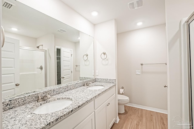 7929 Huntington Creek Ln, Pensacola, FL 32526 - full bathroom with a shower stall, wood finished floors, toilet, baseboards, and double vanity