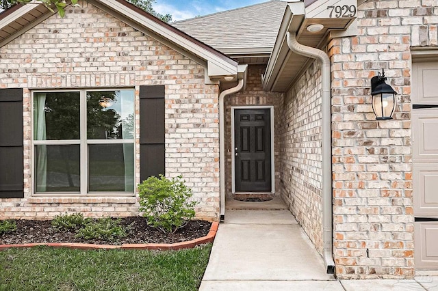 7929 Huntington Creek Ln, Pensacola, FL 32526 - view of exterior entry with a shingled roof and brick siding