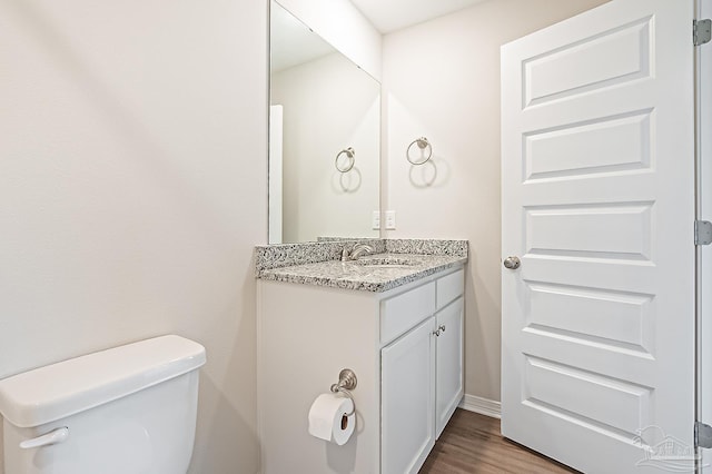 7929 Huntington Creek Ln, Pensacola, FL 32526 - half bathroom featuring vanity, wood finished floors, toilet, and baseboards