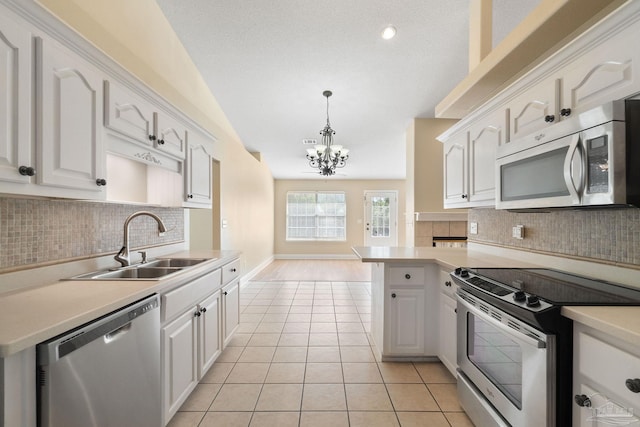 kitchen featuring white cabinetry, appliances with stainless steel finishes, sink, and pendant lighting