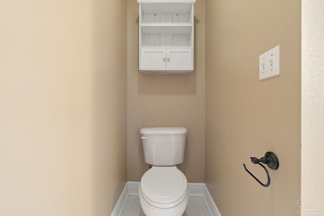 bathroom with tile patterned flooring and toilet