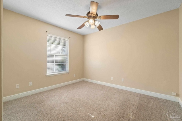 carpeted empty room with ceiling fan and a textured ceiling