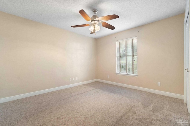 spare room with ceiling fan, carpet, and a textured ceiling