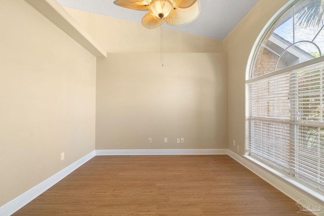 spare room featuring hardwood / wood-style flooring, ceiling fan, and lofted ceiling