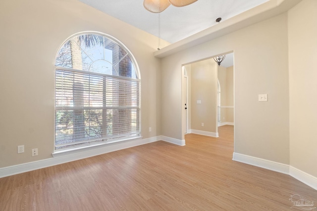 spare room featuring ceiling fan, plenty of natural light, and light wood-type flooring