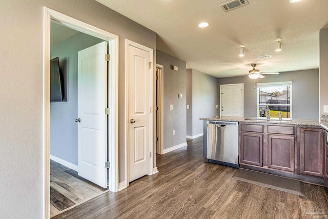 kitchen featuring light stone counters, ceiling fan, sink, dishwasher, and dark hardwood / wood-style floors