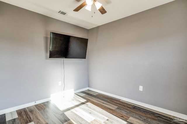 spare room with ceiling fan and wood-type flooring