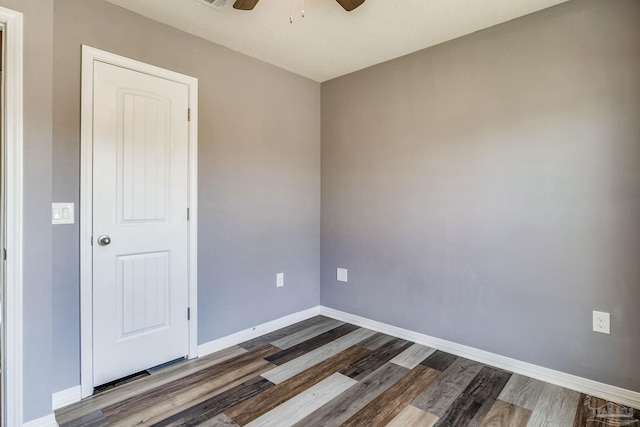 unfurnished room featuring dark hardwood / wood-style flooring and ceiling fan