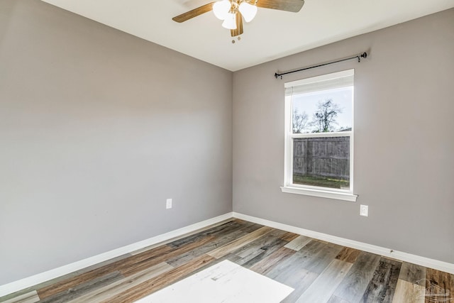 spare room with ceiling fan and wood-type flooring