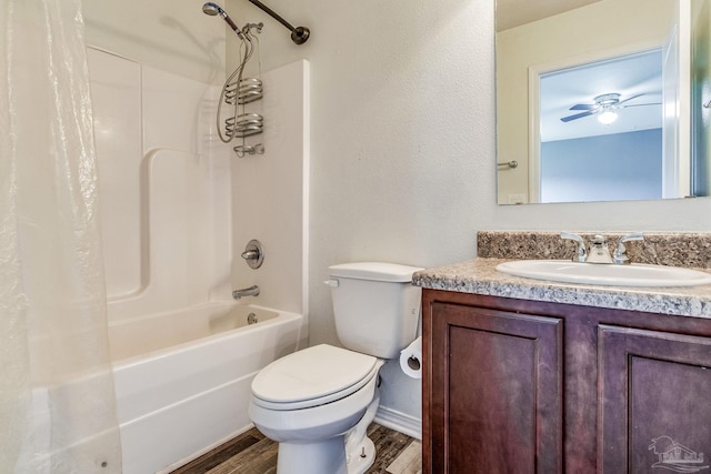 full bathroom featuring shower / bath combo, vanity, hardwood / wood-style flooring, ceiling fan, and toilet