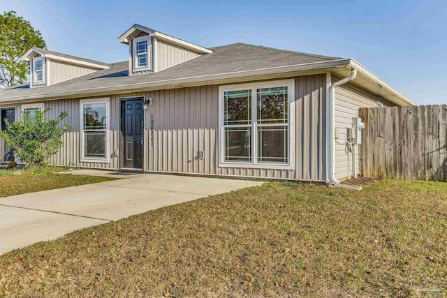 rear view of property with a yard