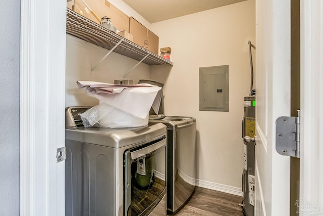 laundry room with a textured ceiling, water heater, independent washer and dryer, electric panel, and dark hardwood / wood-style floors