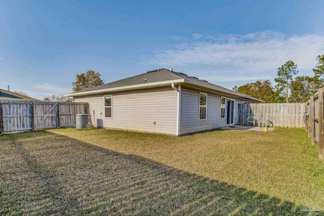 back of house featuring a lawn and cooling unit