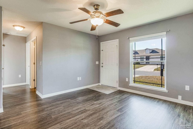 unfurnished room featuring ceiling fan and dark wood-type flooring