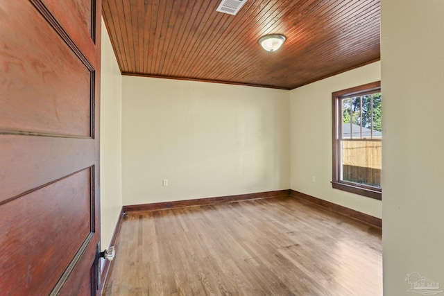 spare room featuring wood-type flooring, wood ceiling, and ornamental molding