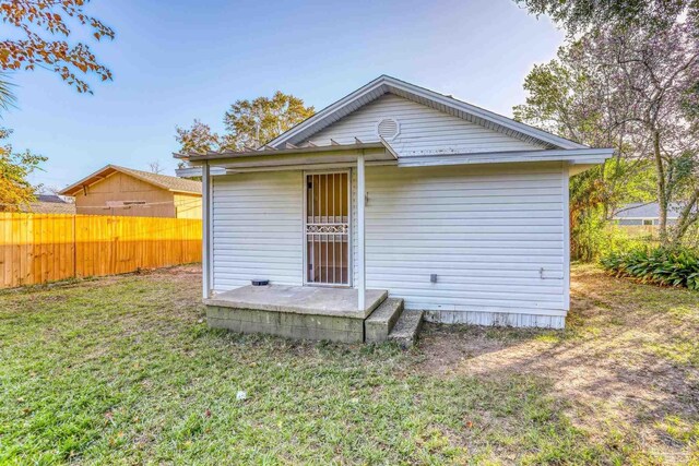 back of property featuring a lawn