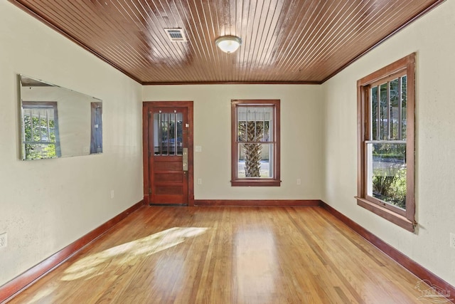 interior space with light hardwood / wood-style floors, wooden ceiling, and crown molding