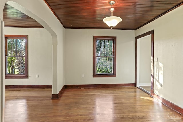 interior space featuring hardwood / wood-style floors, wood ceiling, and ornamental molding