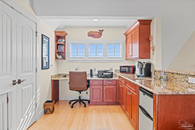 office featuring built in desk and light hardwood / wood-style floors