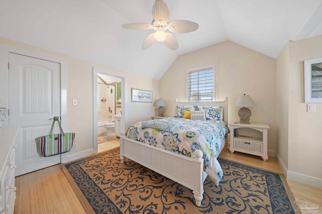 bedroom featuring connected bathroom, ceiling fan, light hardwood / wood-style floors, and vaulted ceiling