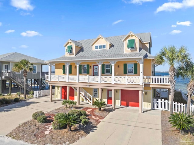 view of front of property featuring covered porch and a garage