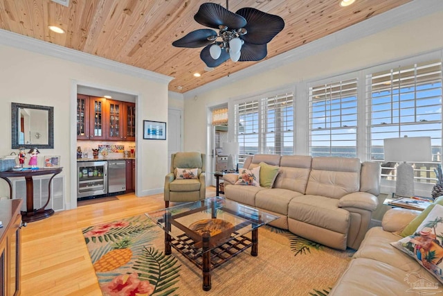 living room with beverage cooler, bar area, crown molding, light hardwood / wood-style floors, and wood ceiling