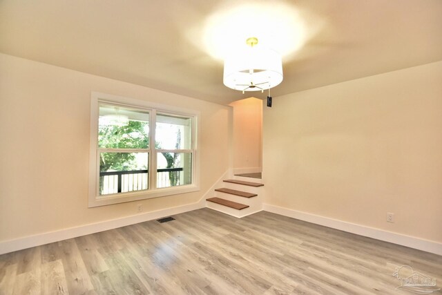 spare room with hardwood / wood-style flooring