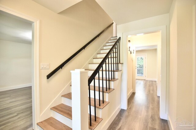 stairway with hardwood / wood-style flooring