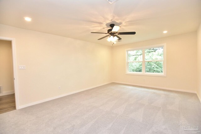 empty room with ceiling fan and carpet flooring