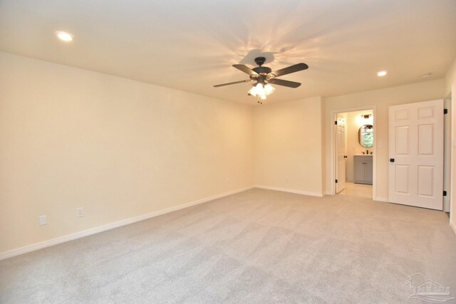 carpeted empty room featuring ceiling fan