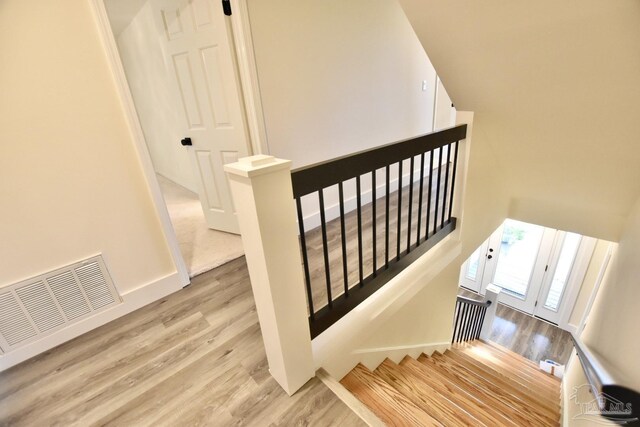 staircase with wood-type flooring