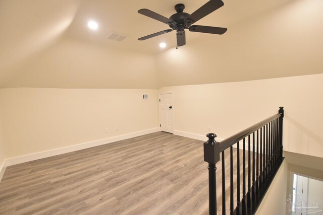 bonus room with lofted ceiling, ceiling fan, and hardwood / wood-style flooring