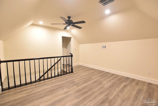 bonus room featuring vaulted ceiling, hardwood / wood-style floors, and ceiling fan