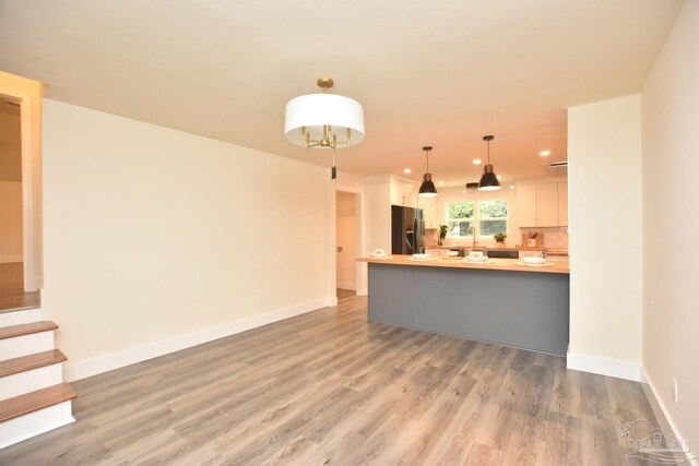 unfurnished living room featuring wood-type flooring