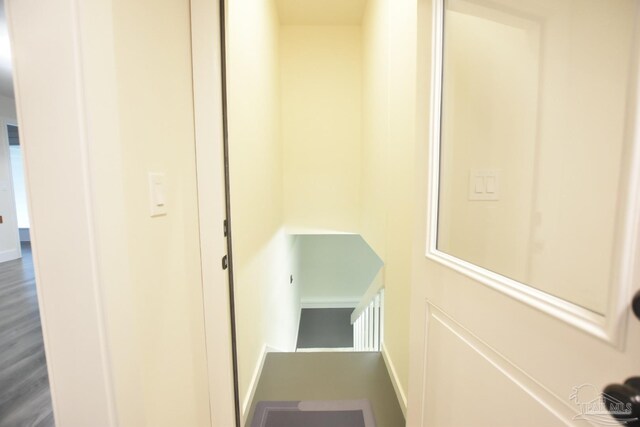 hallway with hardwood / wood-style flooring