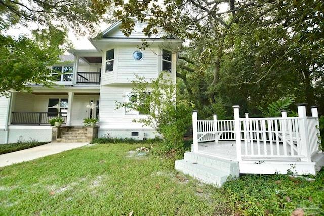 exterior space with a balcony and a lawn