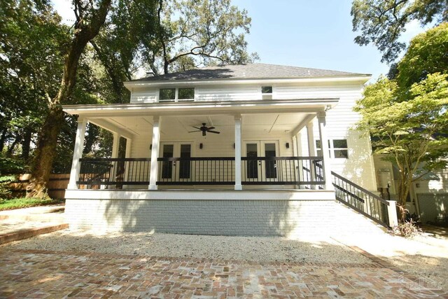 rear view of property featuring ceiling fan and covered porch